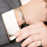 Model Wearing Pangolin Shield Bangle in Sterling Silver, Pagolin Shield Cufflinks in Sterling Silver and Pangolin Shield Ring in Sterling Silver