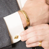 Model Wearing Pangolin Shield Cufflinks in 18ct Gold, Pangolin Shield Bangle in 18ct Gold and Pangolin Shield Ring in 18ct Gold
