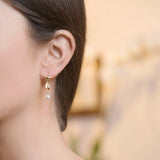 Model Wearing Starfish Cowrie Drop Earrings in 18ct Gold