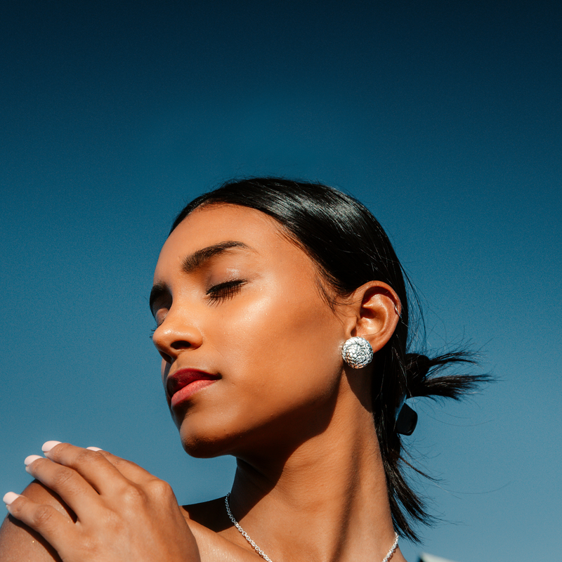 Pangolin Rolled Sterling Silver Studs worn by a model to show the actual size and real life look